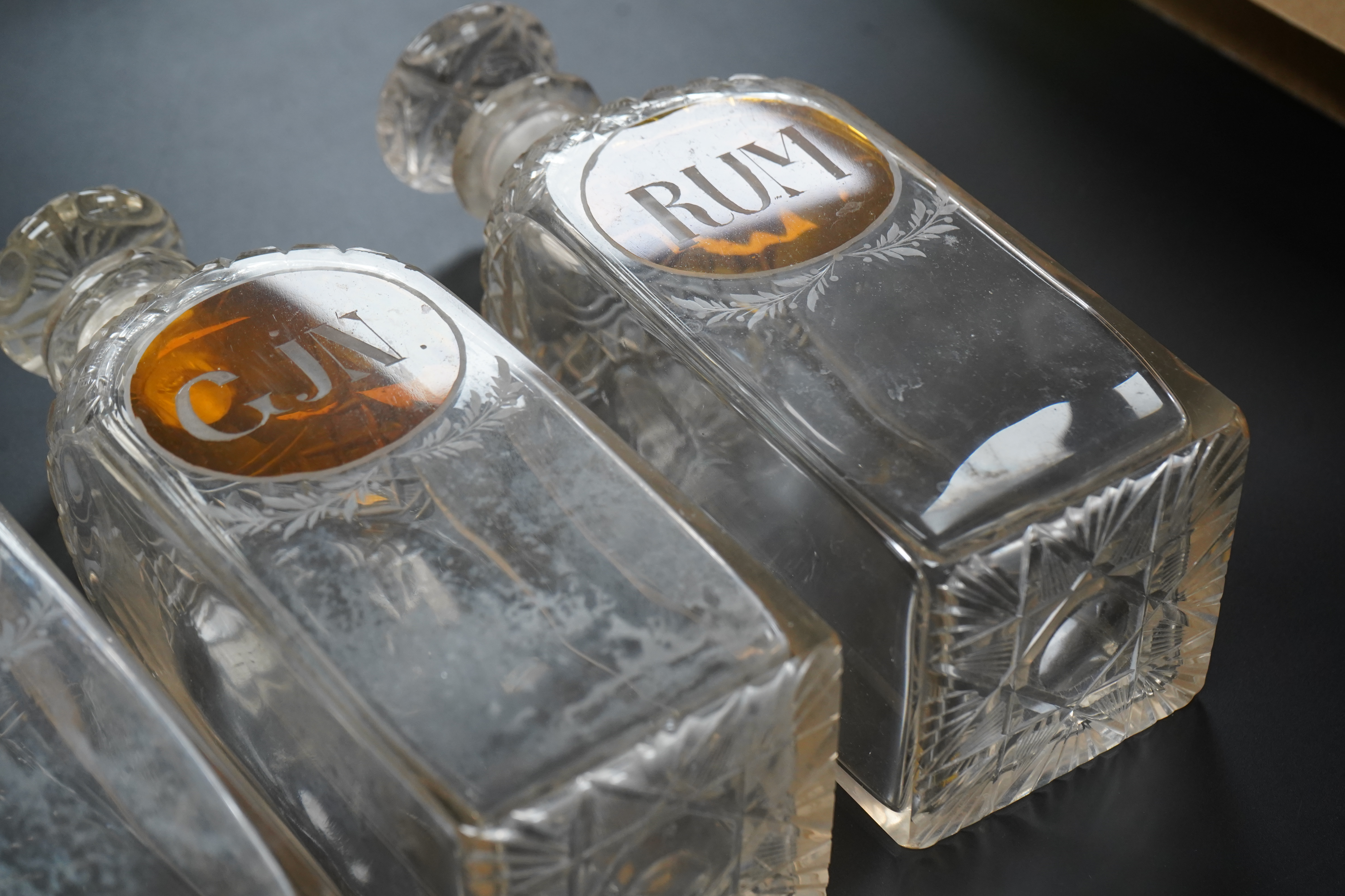 Three 19th century cut glass decanters for 'Rum' 'Gin' and 'Brandy', 23cm high